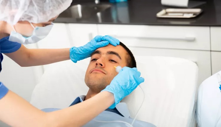 انجام کربوکسی تراپی روی صورت مرد توسط پزشک